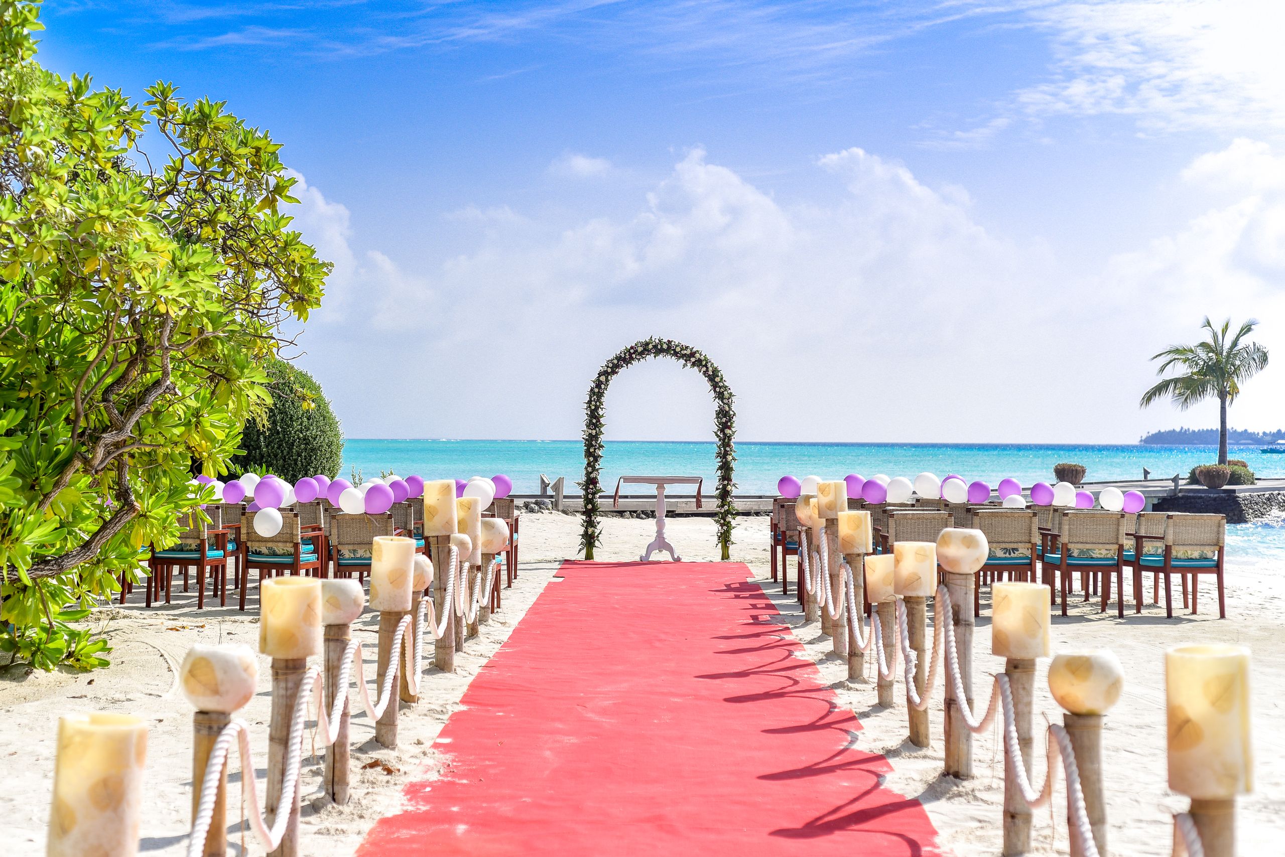Floral wedding aisle facing the lagoon at sunset